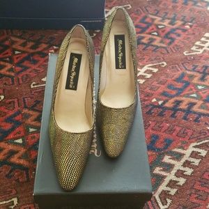 Gold and black high heeled shoes